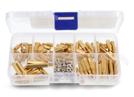 A set of screws and spacer sleeves in a transparent and open container.