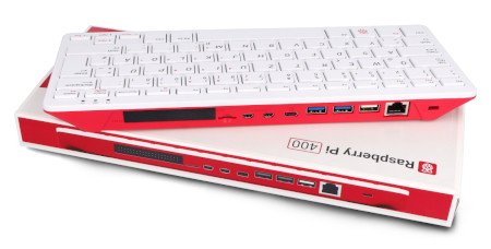 A keyboard with a built-in Raspberry Pi 400 computer in pink and white colors lies on the packaging.