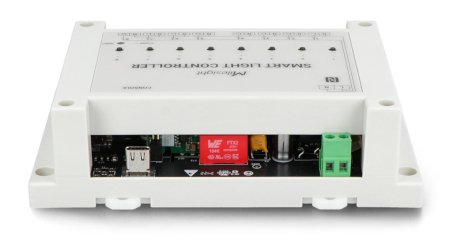 The creamy white lorawan lighting controller lies on a white background from an underside perspective.