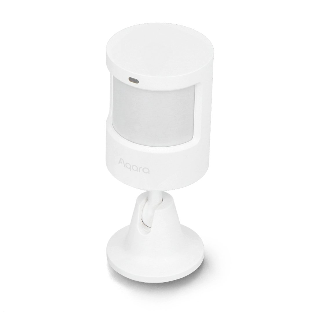 A white motion and light sensor stands on a white background.