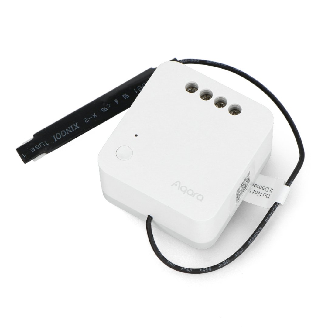 A white flush-mount relay with a black wire lies on a white background.