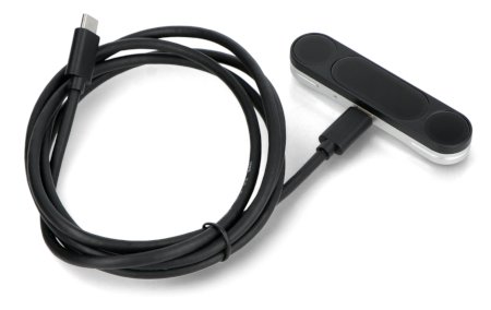 A black gesture sensor with a connected wire lies on a white background.
